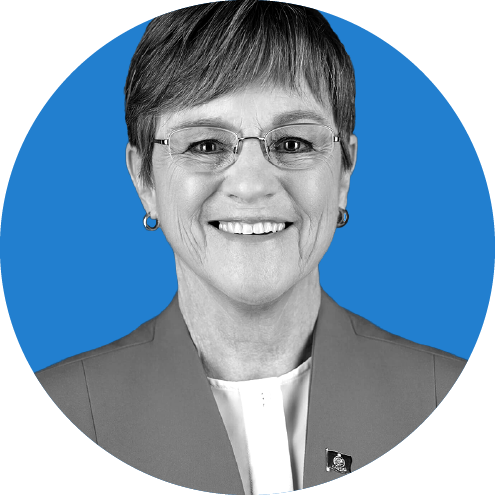 Headshot of Kansas Governor Laura Kelly on a blue background.