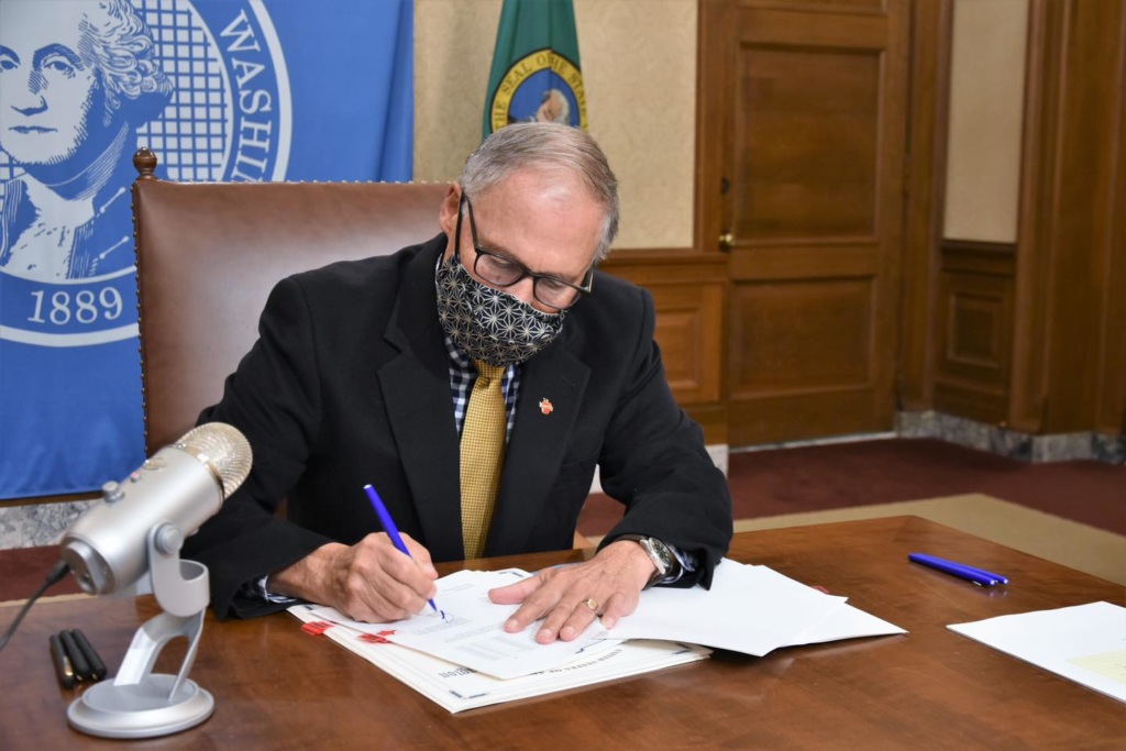 Gov. Jay Inslee signs legislation.