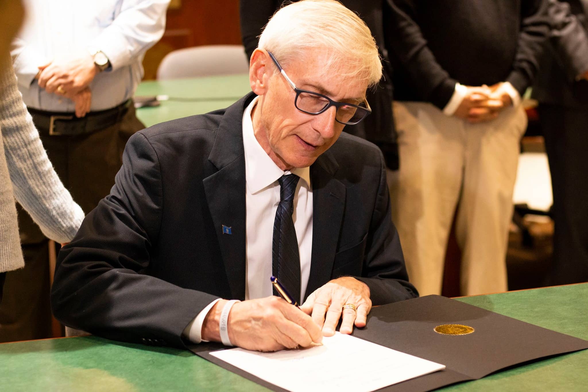 Gov. Tony Evers signs a bill into law.