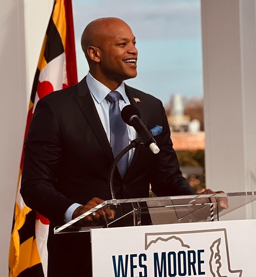 Maryland Gov. Wes Moore standing at a podium in front of the Maryland flag.