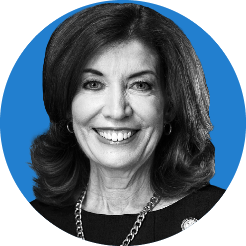 Headshot of New York Governor Kathy Hochul on a blue background.