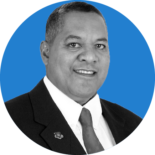 Headshot of American Samoa Governor Lemanu P.S. Mauga on a blue background.